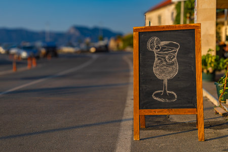 Wooden advertisement for a seafood restaurant on the main street of Trpanj Croatiaの写真素材