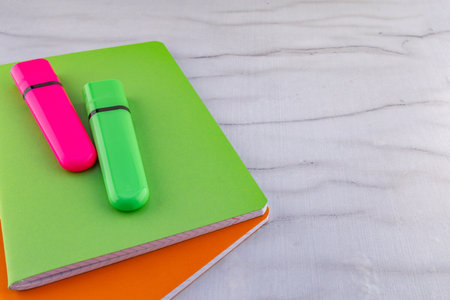 A green marker for marking text placed in the notebook preparing school supplies for the beginning of the school yearの写真素材