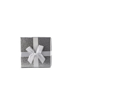 Silver decorative square small box with white bow on white background for Christmas gifts for wife, for husband, for girlfriend, for boyfriendの写真素材
