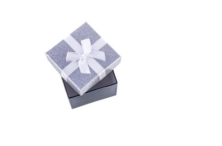 Silver decorative square small box with white bow on white background for Christmas gifts