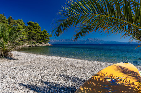 Rocky beach, Mediterranean coast in Croatia, water sports, rest and relaxation by the water, Windsurfing, active recreation by the water, Adriatic Sea in Croatia, rocky coastの写真素材