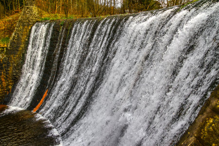 High water level on the Vistula River, water falling from the waterfallの写真素材