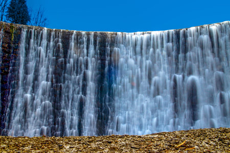 High water level on the Vistula River, water falling from the waterfallの写真素材