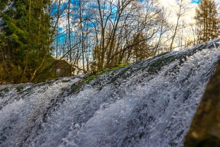 High water level on the Vistula River, water falling from the waterfall