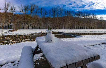 A walk along the river in the mountains, a small snowman made by children
