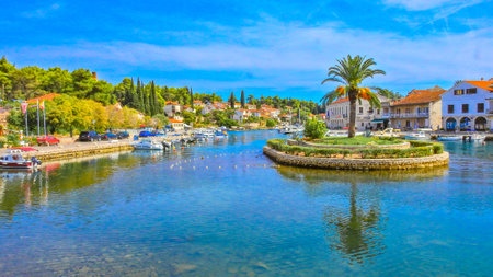 City panorama, view of the monuments of Vrboska, attractions on the island of Hvar, moored boats in...