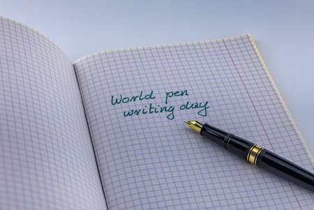 pen on white background in man's handの写真素材