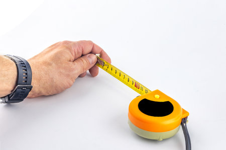 Metal construction tape measure, rolled measuring tape, tape measure on white background