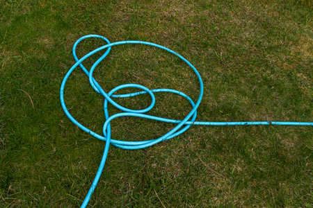 Blue twisted lawn hose, Gordian knot,