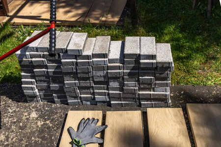 Gray granite cubes stacked in the garden, preparation for laying tiles and cubes on the veranda in the gardenの写真素材