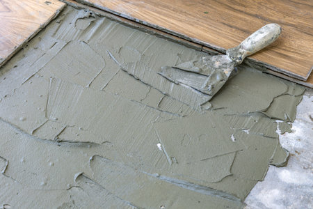 Laying tiles on a terrace in the garden, gluing tiles with frost-resistant glue on a veranda under a...