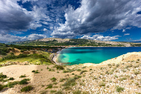 Hiking trail leading from the beach in Baska to the Bag mountain, city panorama seen from above, azure water in the bay by the beach in Baskaの写真素材