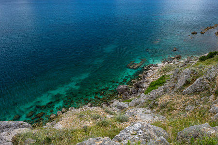 Hiking trail leading from the beach in Baska to the Bag mountain, city panorama seen from above, azure water in the bay by the beach in Baskaの写真素材