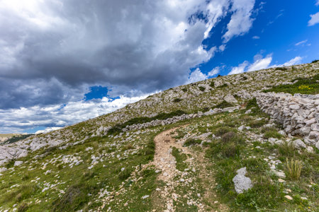 Climbing the Bag peak on the island of KRK, a view of the panorama of the city of Baska, sharp rocks, azure water, the Adriatic Seaの写真素材