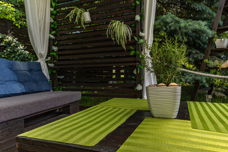 Wooden pergola in the garden with pallet furniture and a Brazilian swing hammock, a place to relax...