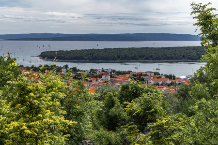 The Three Crosses Sanctuary on the hill in Punat, entrance via a steep rocky path to the temple, view of the panorama of the town of Punat in KRKの写真素材