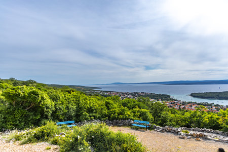 The Three Crosses Sanctuary on the hill in Punat, entrance via a steep rocky path to the temple, view of the panorama of the town of Punat in KRKの写真素材