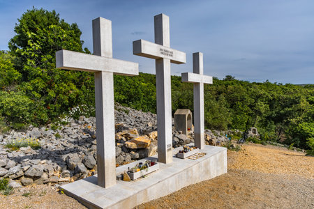 The Three Crosses Sanctuary on the hill in Punat, entrance via a steep rocky path to the temple, view of the panorama of the town of Punat in KRKの写真素材