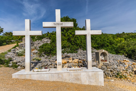 The Three Crosses Sanctuary on the hill in Punat, entrance via a steep rocky path to the temple, view of the panorama of the town of Punat in KRKの写真素材