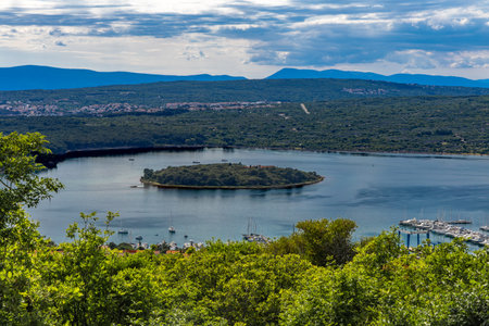 The Three Crosses Sanctuary on the hill in Punat, entrance via a steep rocky path to the temple, view of the panorama of the town of Punat in KRKの写真素材