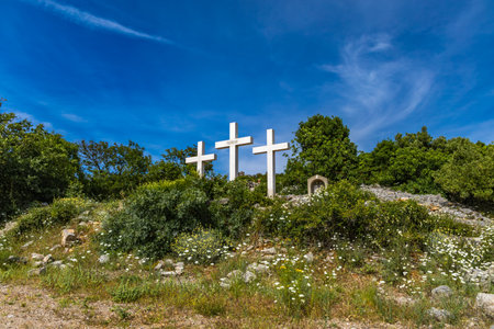 The Three Crosses Sanctuary on the hill in Punat, entrance via a steep rocky path to the temple, view of the panorama of the town of Punat in KRKの写真素材