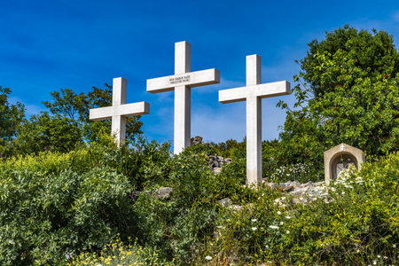 The Three Crosses Sanctuary on the hill in Punat, entrance via a steep rocky path to the temple, view of the panorama of the town of Punat in KRKの写真素材