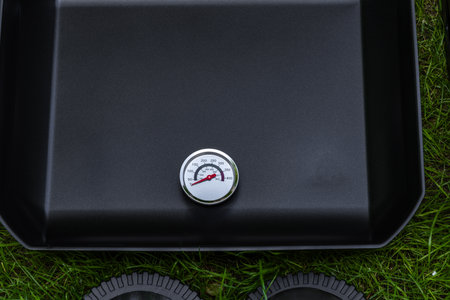 Assembling a new grill on the plot, installing an electric grill, hotplate, thermostat, power cable, preparations for a summer barbecueの写真素材