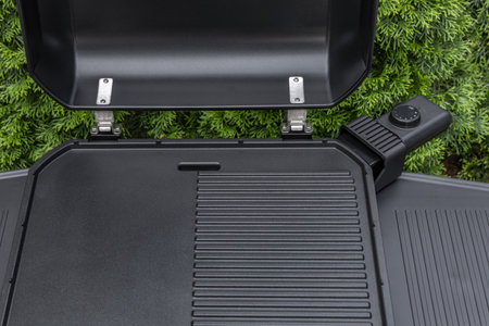 Assembling a new grill on the plot, installing an electric grill, hotplate, thermostat, power cable, preparations for a summer barbecueの写真素材