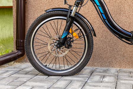 Flat tire on electric bike, pumping air into bike inner tube, bike inspection and repair before the seasonの写真素材