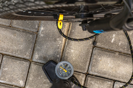 Flat tire on electric bike, pumping air into bike inner tube, bike inspection and repair before the seasonの写真素材