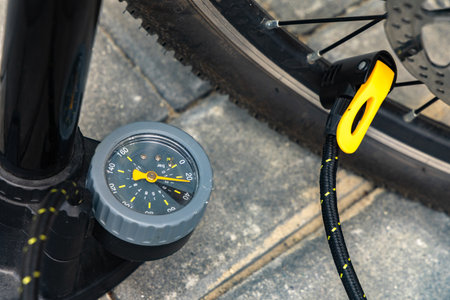 Flat tire on electric bike, pumping air into bike inner tube, bike inspection and repair before the seasonの写真素材