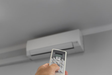 Air Conditioning Remote Control, Air Conditioner Hanging On White Wall Under Ceiling, Air Conditioner Repairの写真素材