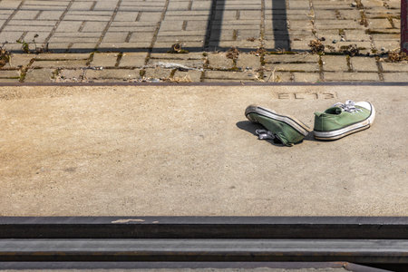 Green sports shoes by the tracksの写真素材