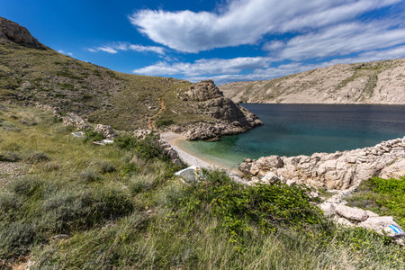 The picturesque bay and pebbly empty beach of Gnjilova on the island of KRK, a beach on the tourist trail from Vela Luka to BaÅ¡kaの写真素材