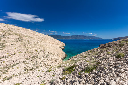 The picturesque bay and pebbly empty beach of Konjska on the island of KRK, a beach on the tourist trail from Vela Luka to BaÅ¡kaの写真素材