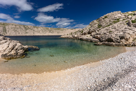 The picturesque bay and pebbly empty beach of Gnjilova on the island of KRK, a beach on the tourist trail from Vela Luka to BaÅ¡kaの写真素材
