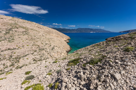 The picturesque bay and pebbly empty beach of Konjska on the island of KRK, a beach on the tourist trail from Vela Luka to BaÅ¡kaの写真素材