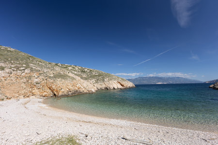 The picturesque bay and pebbly empty beach of Konjska on the island of KRK, a beach on the tourist trail from Vela Luka to BaÅ¡kaの写真素材