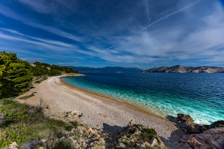 The picturesque bay and pebbly empty beach of beach VreÅ¾enica on the island of KRK, a beach on the tourist trail from Vela Luka to BaÅ¡kaの写真素材