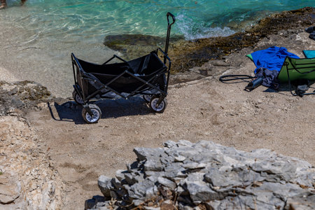 A beach cart with wheels, a cart for transporting toys, food, mattresses, and sun loungers to the beach.の写真素材