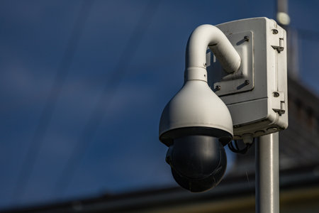 City monitoring system, cameras in a public park, devices recording people in a park on a street in...
