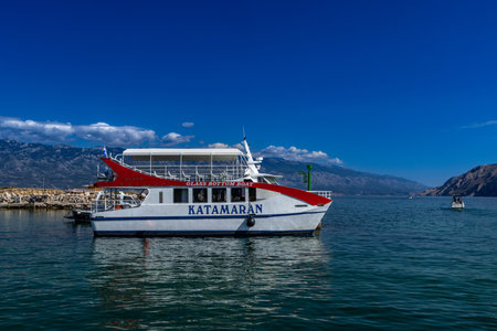 Tourist attraction glass-bottomed excursion boat, ship in the harbor on the island of Rab in Lopar Croatiaの写真素材