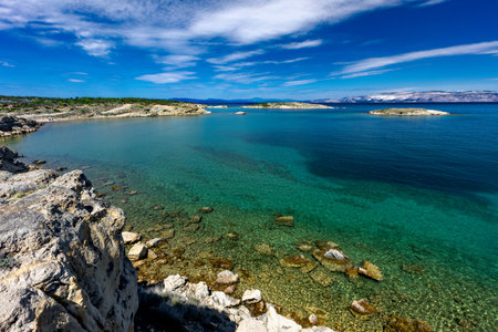 Azure water in the Adriatic Sea, rocky coast of the island of Rab, cloudy, threatening sky, panorama...