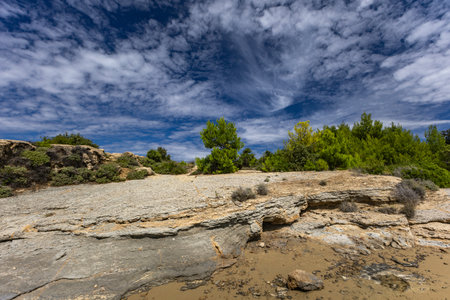 Azure water in the Adriatic Sea, rocky coast of the island of Rab, cloudy, threatening sky, panorama...