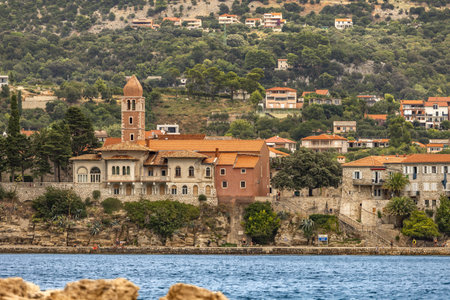 Panorama and view of the town of Rab from the bay, four towers, church tower and bell tower, cloudy stormy sky Croatiaの写真素材
