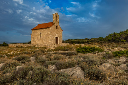 Sunset Votive Church of St. Nicholas built in 1447, sanctuary on the island of Rab, Cape Sorinja, church renovated in 2012の写真素材