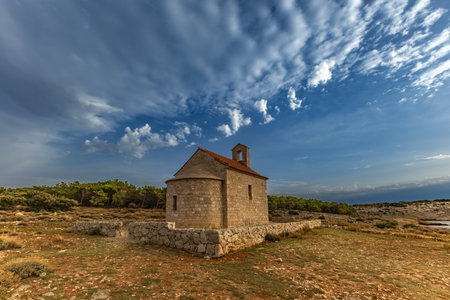 Sunset Votive Church of St. Nicholas built in 1447, sanctuary on the island of Rab, Cape Sorinja, church renovated in 2012の写真素材