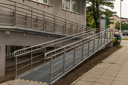 Accessible ramp for disabled people, metal ramp with handrails for strollers and disabled people, architectural accessibility of public buildingsの写真素材