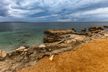 Tara Beach on the island of Rab, Straw sun umbrellas on the shore of the Adriatic Sea, Croatiaの写真素材