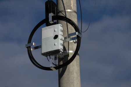 High-speed internet connection, fiber-optic internet network, pole with power lineの写真素材